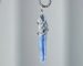 Natural blue kyanite pendant necklace with hand-soldered tin wire design, resembling ocean waves and glaciers.